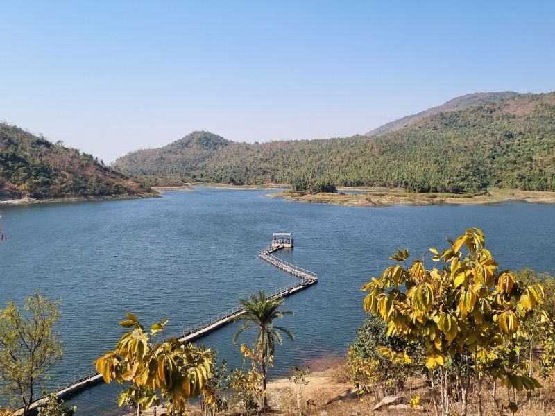 Turga Dam reservoir with calm blue waters surrounded by green hills in Purulia
